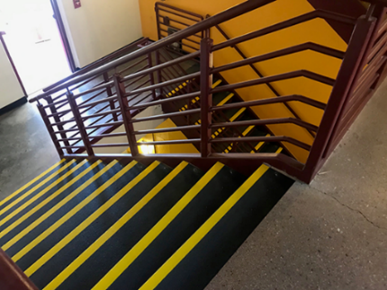 Two tone black and yellow step covers on concrete steps