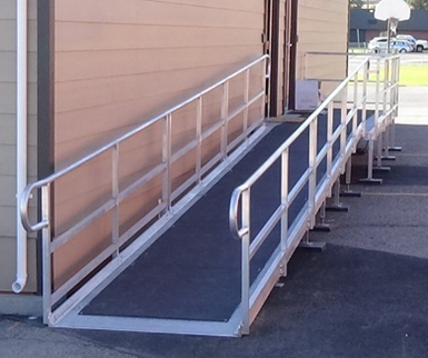 Silver-colored metal ramp Walkway with black anti-slip cover