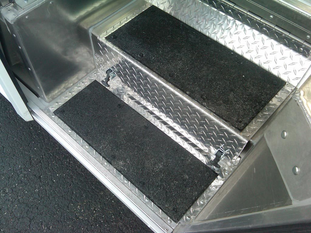 Non-slip walkway covers over diamond plate steps in a walk-in van