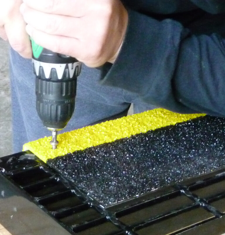 grating installed with screwdriver
