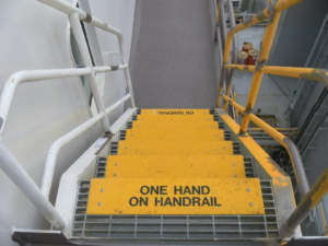 ellow Safeguard Hi-Traction® anti-slip step covers with descriptive messaging