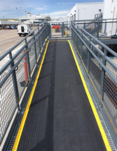 Safeguard Hi-Traction® anti-slip walkway and ramp covers on grating