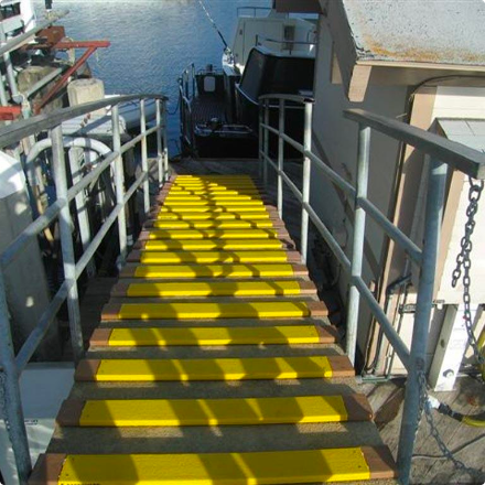 Yellow Anti-slip safety steps on wood on vessel