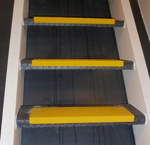 yellow anti-slip covers over black textured metal stairs