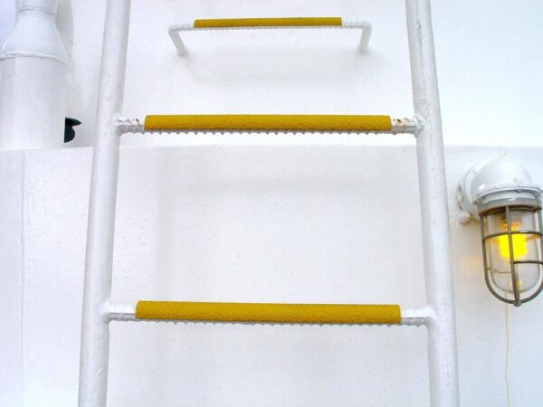 Yellow Round Ladder Rung Covers on white metal ladder