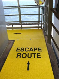 Image of Safeguard anti-slip walkway cover with safety messaging, escape route, embedded on surface.